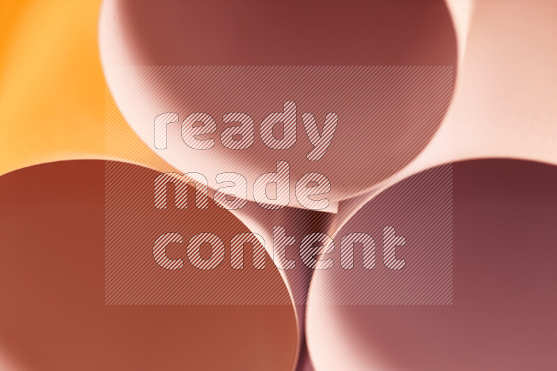 The image shows an abstract paper art with circular shapes in varying shades of orange