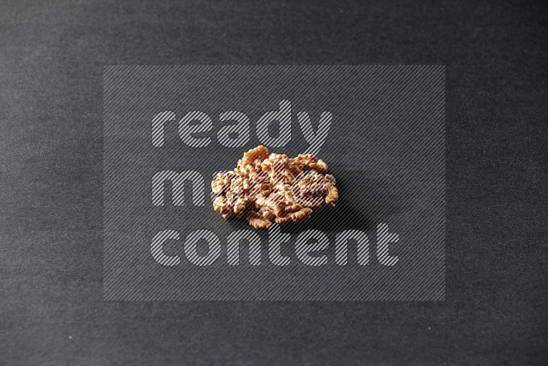 A bunch of walnuts on a black background in different angles