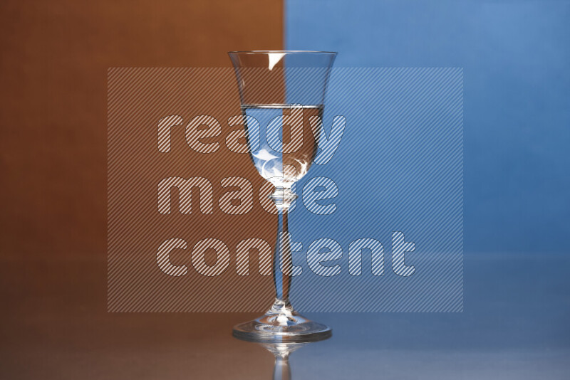 The image features a clear glassware filled with water, set against brown and blue background