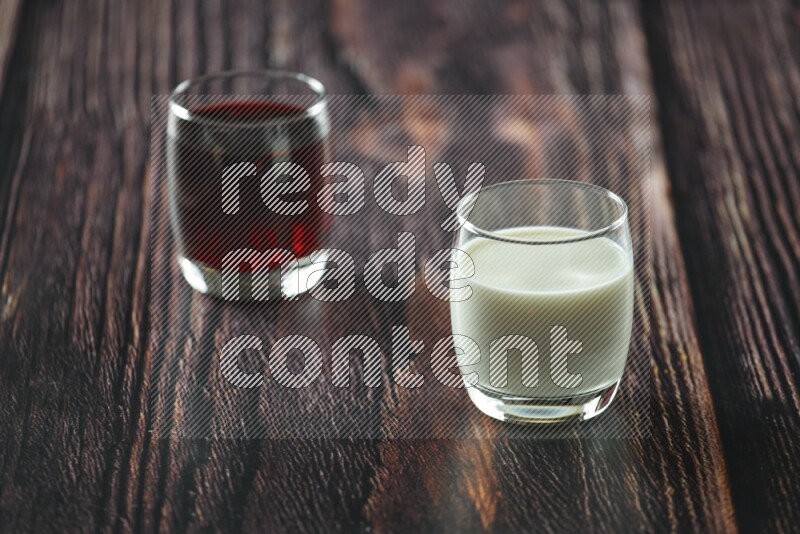 Cold drinks in a glass cup such as water, tamarind, qamar eldin, sobia, milk and hibiscus on wooden background