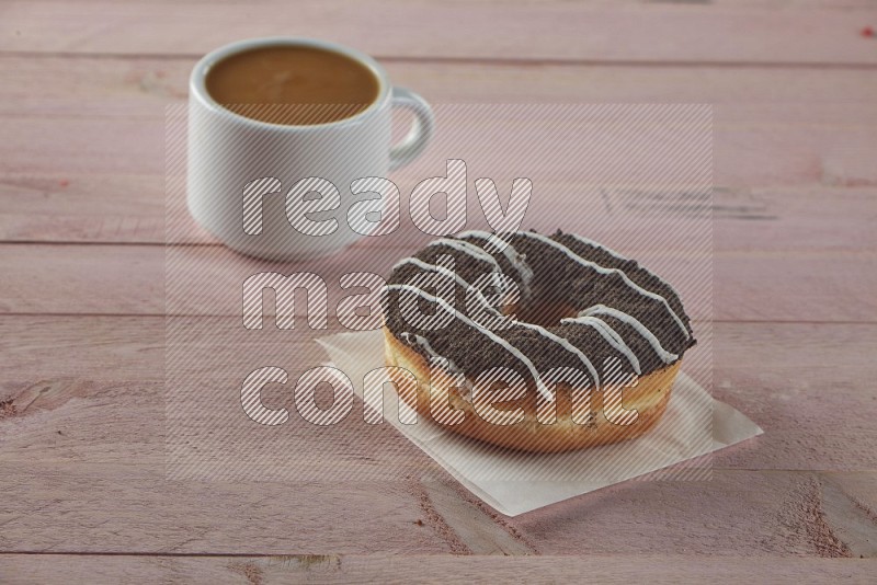 Chocolate crumbs doughnut on pink wooden background