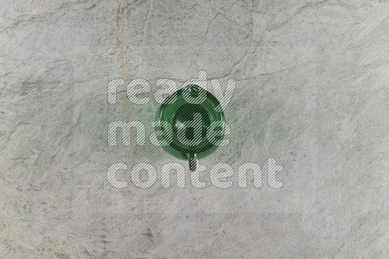 Top View Shot Of An Empty Glass Jug On Grey Marble Flooring