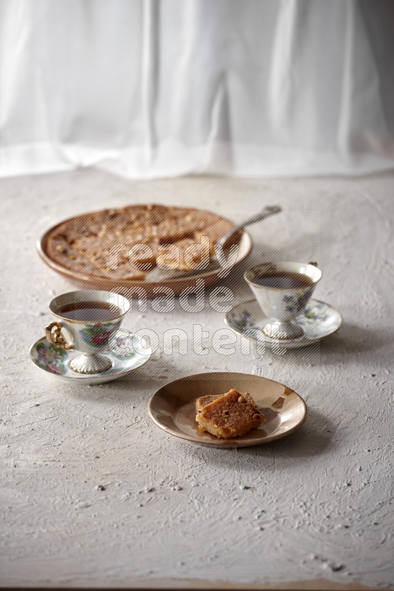 Basbousa with tea in a light setup