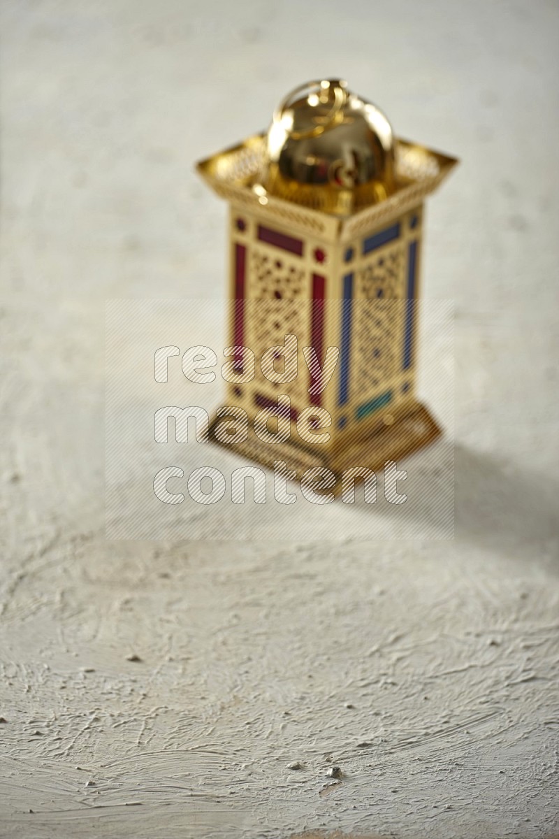An out of focus lantern on textured white background