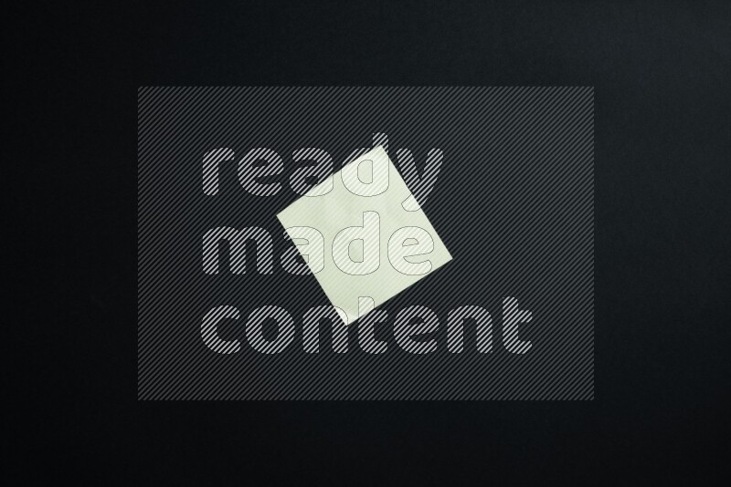 Green paper sheet on black background