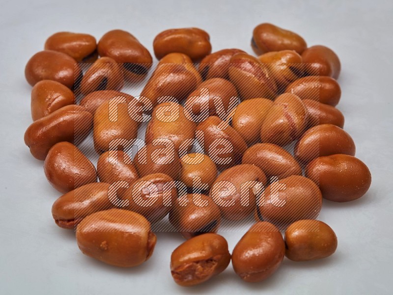 Close up shot of cooked fava beans (foul) on white background