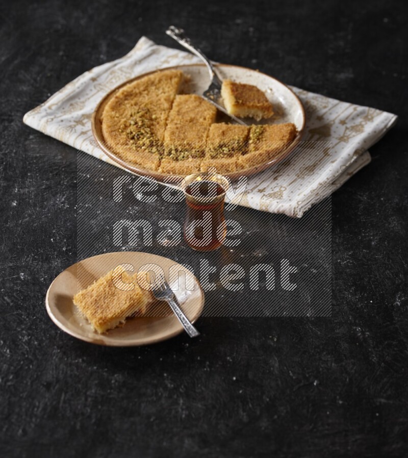 konafa with tea in a dark setup