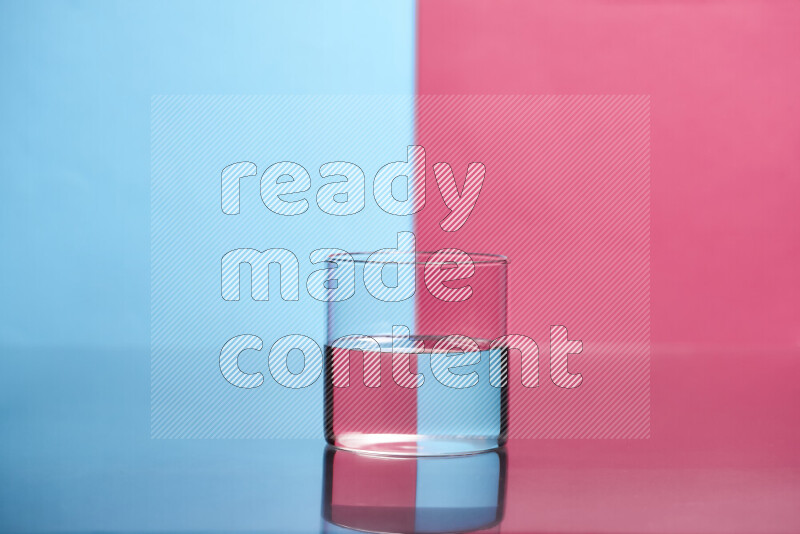 The image features a clear glassware filled with water, set against light blue and pink background