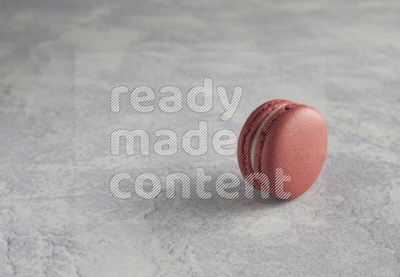 45º Shot of Red Velvet macaron on white  marble background