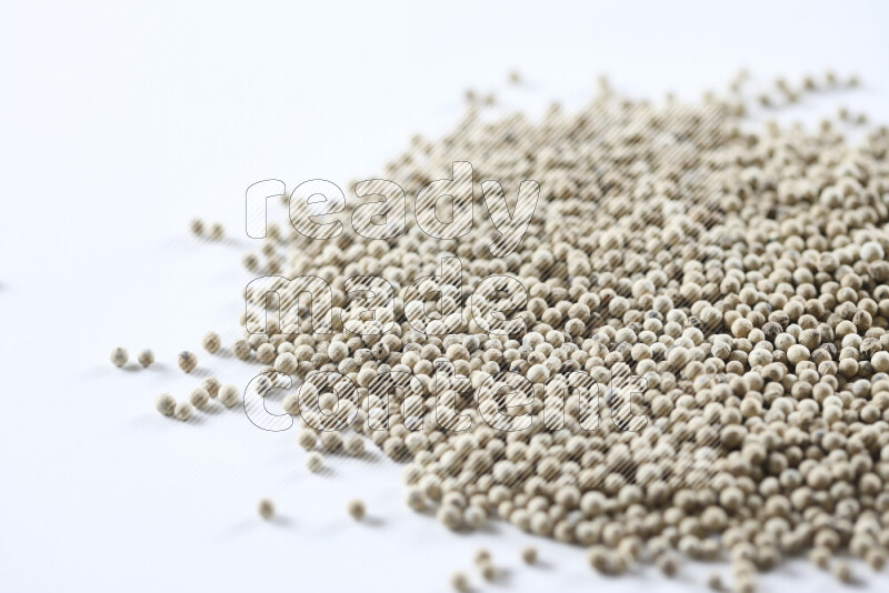 White pepper beads on white background