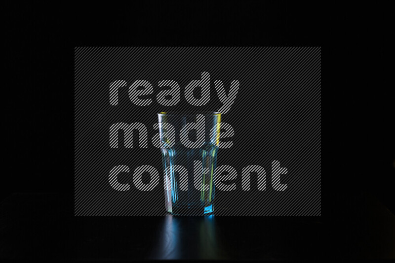 Glassware with rim light in yellow and white against black background