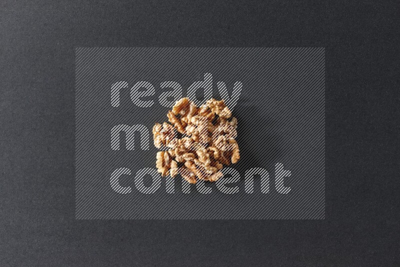 A bunch of walnuts on a black background in different angles