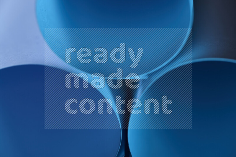 The image shows an abstract paper art with circular shapes in varying shades of blue