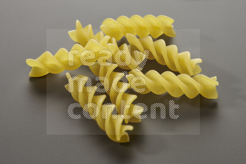 Fusilli pasta on grey background