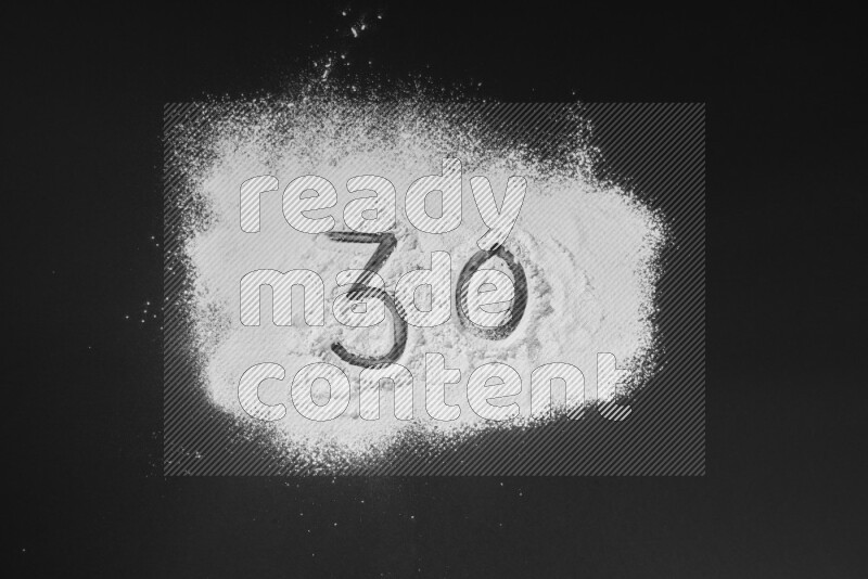 Numbers written with powder on black background