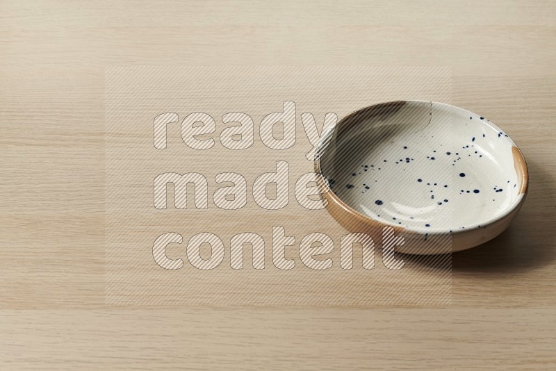 Multicolored Pottery Bowl on Oak Wooden Flooring, 45 degrees