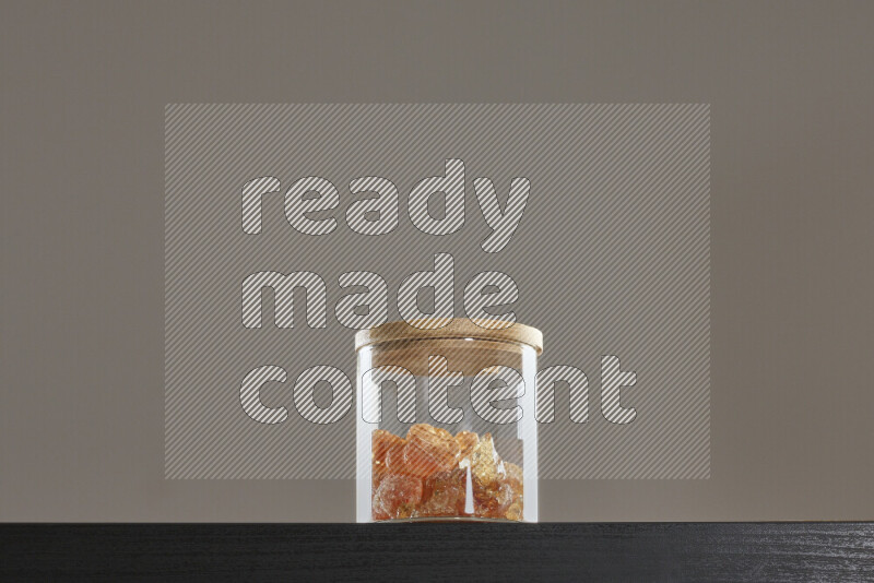 صمغ عربي في وعاء زجاجي على خلفية سوداء