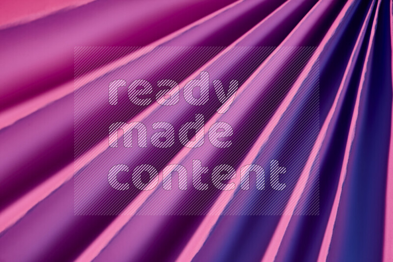 An image presenting an abstract paper pattern of lines in purple tones