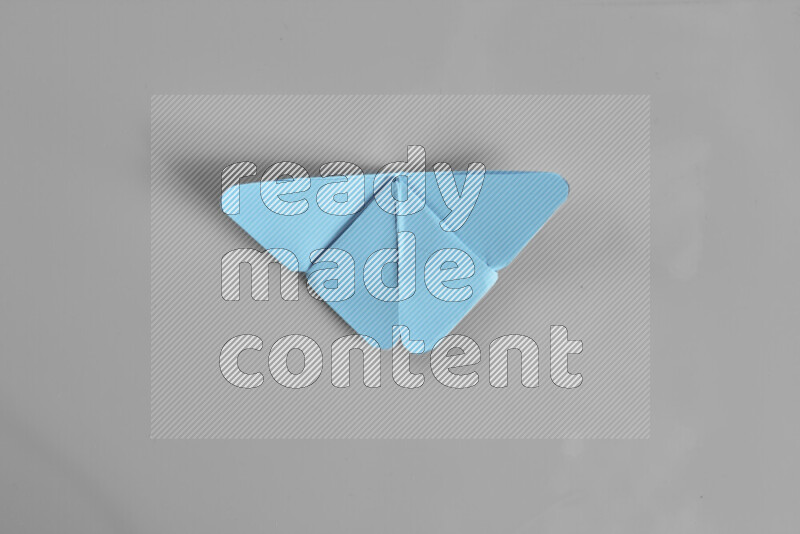 Origami butterfly on grey background