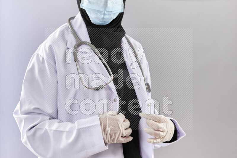Female doctor wearing an abaya and medical attire in different positions