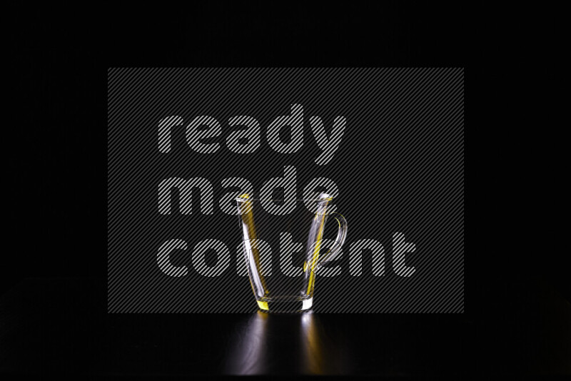 Glassware with rim light in yellow and white against black background