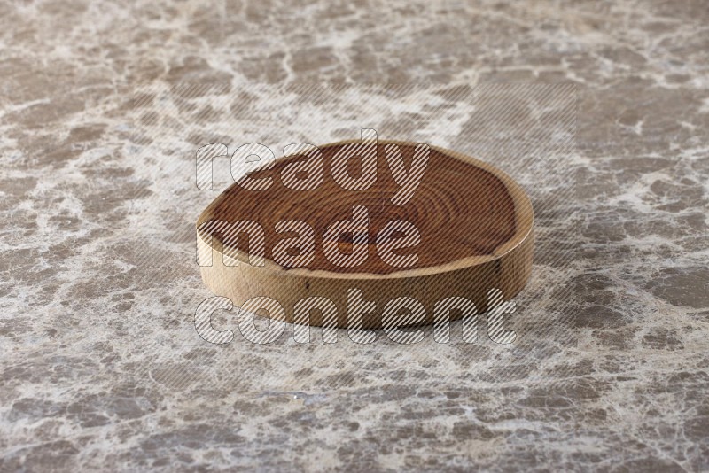 A wooden tray on beige marble background