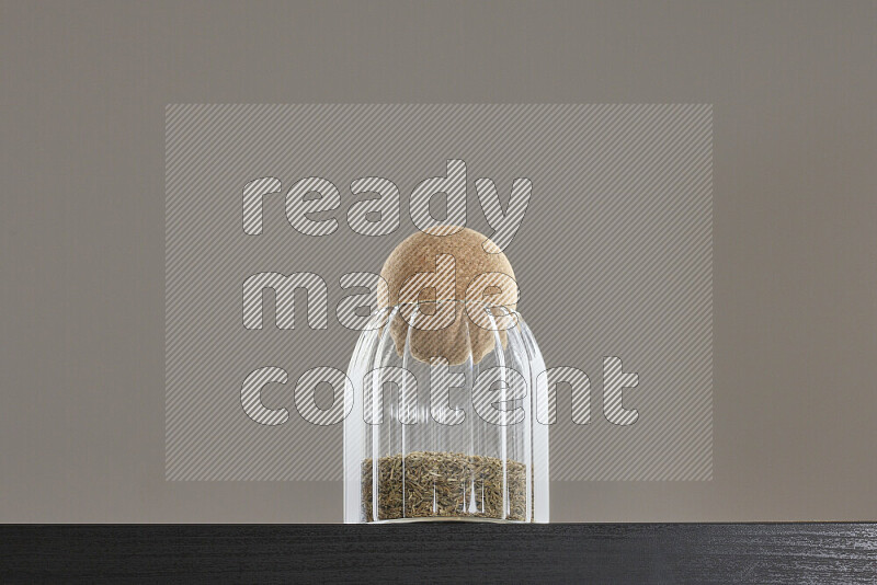 Cumin in a glass jar on black background