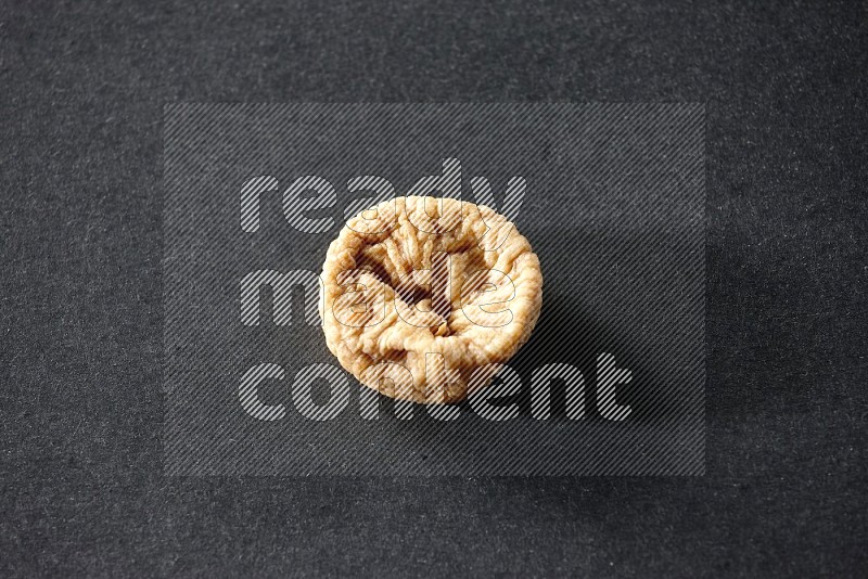 A dried fig on a black background in different angles
