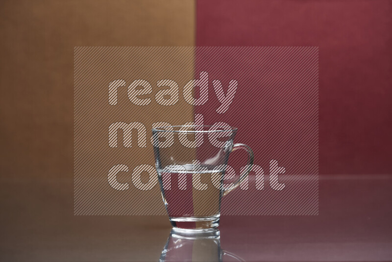 The image features a clear glassware filled with water, set against brown and dark red background