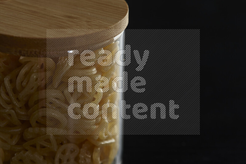 Snacks in a glass jar on black background