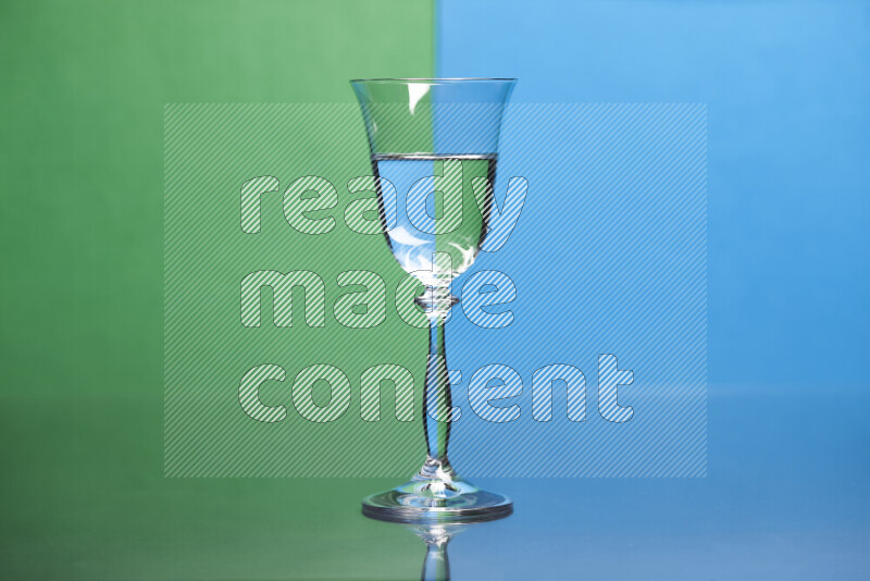 The image features a clear glassware filled with water, set against green and blue background