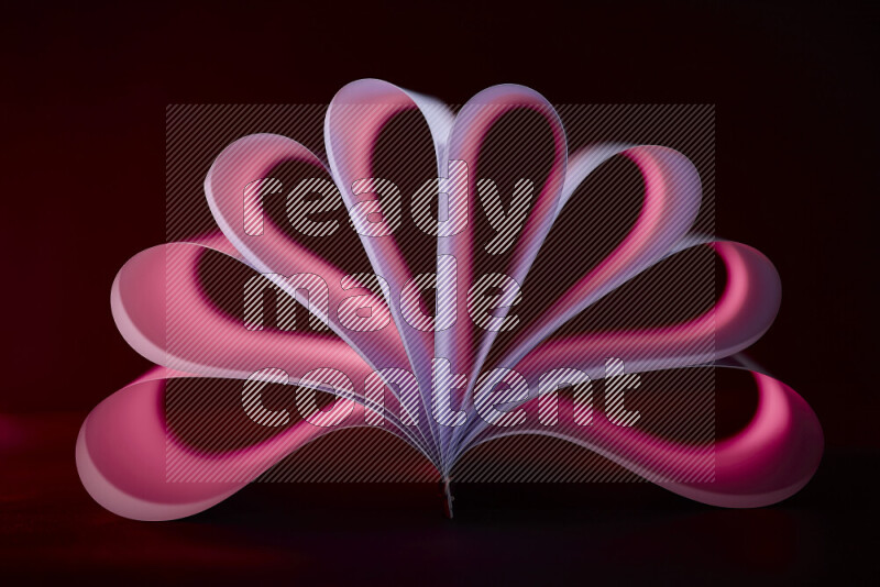 An abstract art piece displaying smooth curves in pink and purple gradients created by colored light