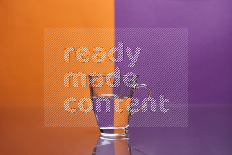 The image features a clear glassware filled with water, set against orange and purple background