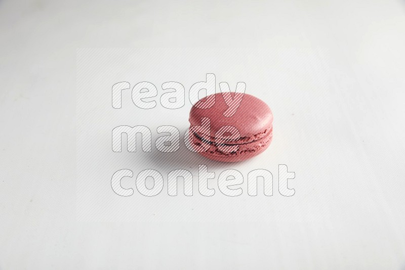 45º Shot of Pink Raspberry macaron on white background