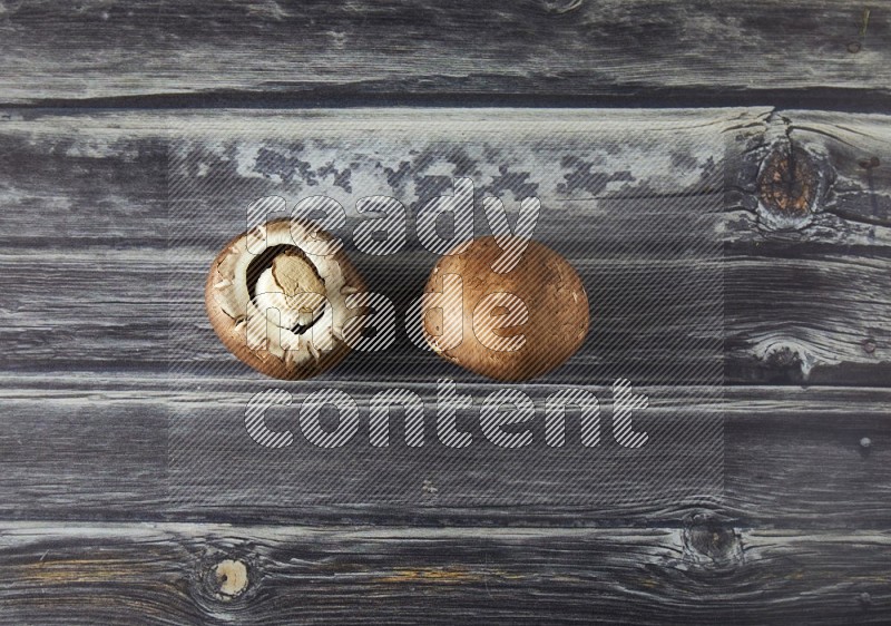 small fresh Cremini wood mushrooms topview on grey wooden textured background