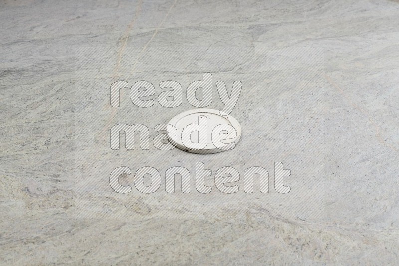 White Pottery Bowl's Lid On Grey Marble Flooring