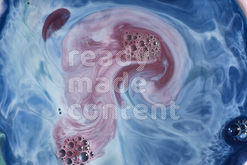 A close-up of abstract swirling patterns in blue, red and white