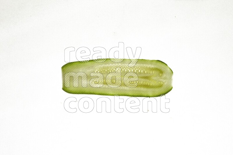 Zucchini slices on illuminated white background