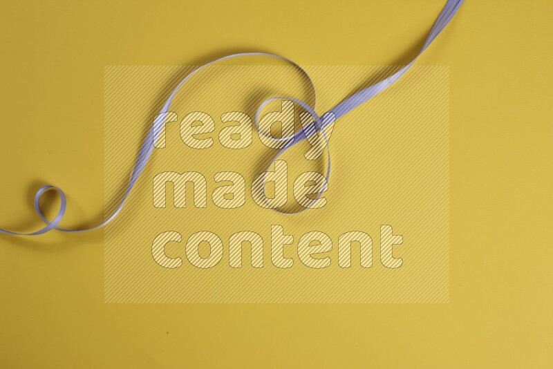 A purple collection of sewing and tailoring tools arranged on a yellow background