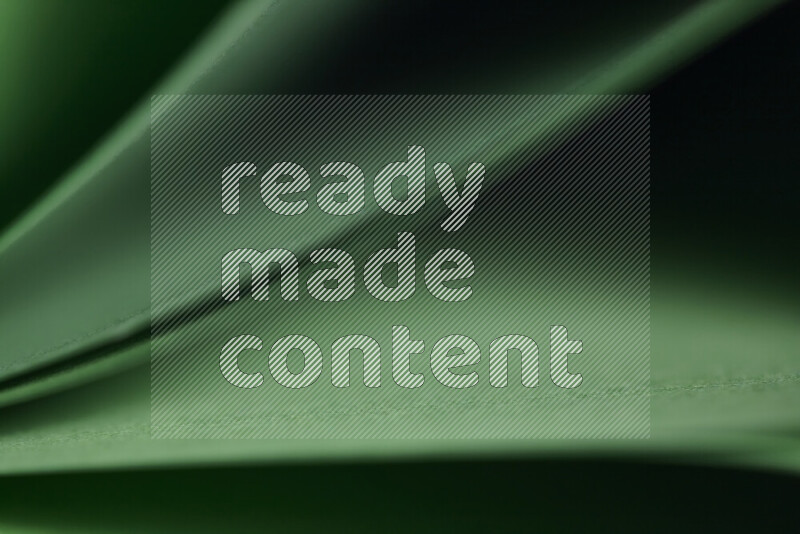 An abstract art showing green paper sheets arranged in an overlapping curves