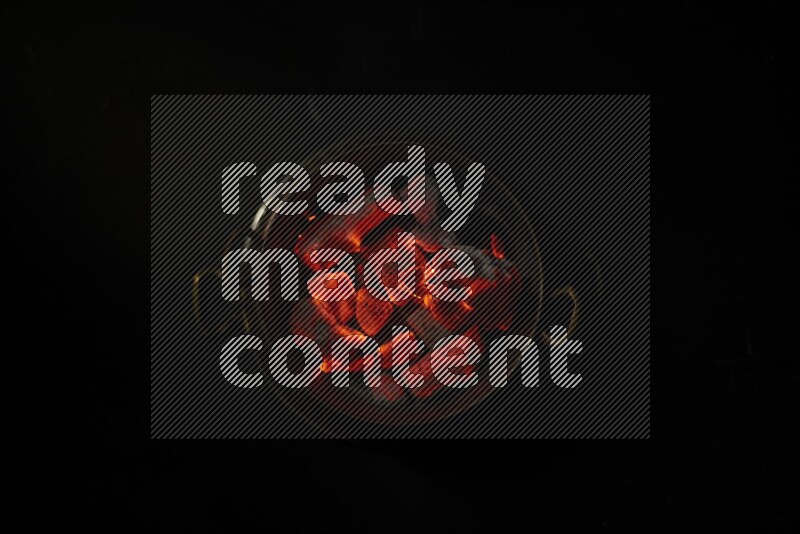 Coal cubes on fire in metal pan