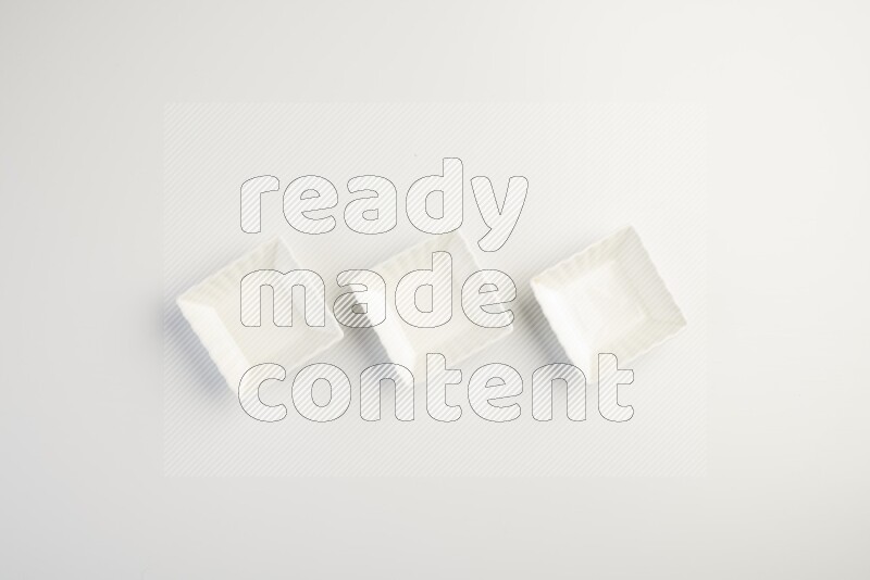 white ceramic square sauce dish on white countertop