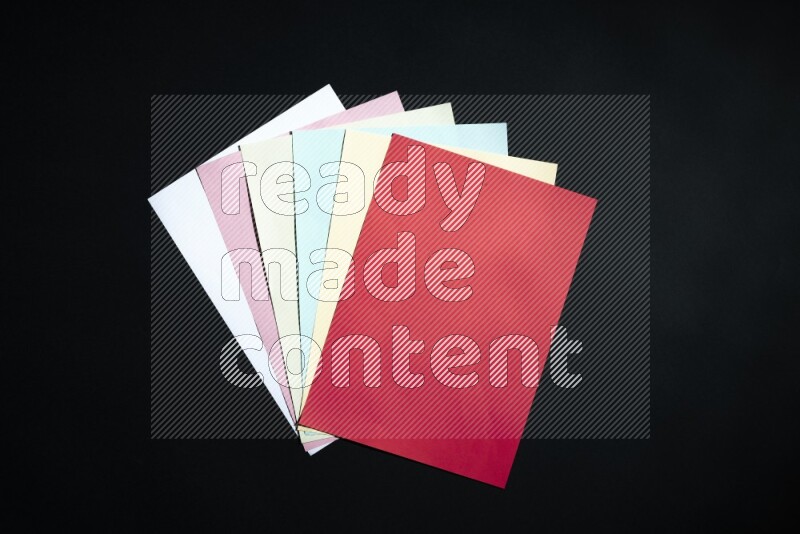 Multicolored paper sheet on black background