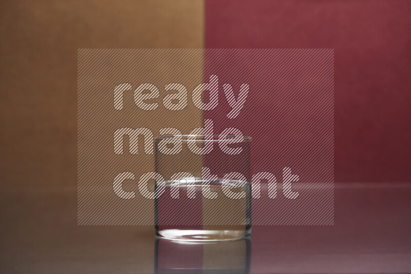 The image features a clear glassware filled with water, set against brown and dark red background