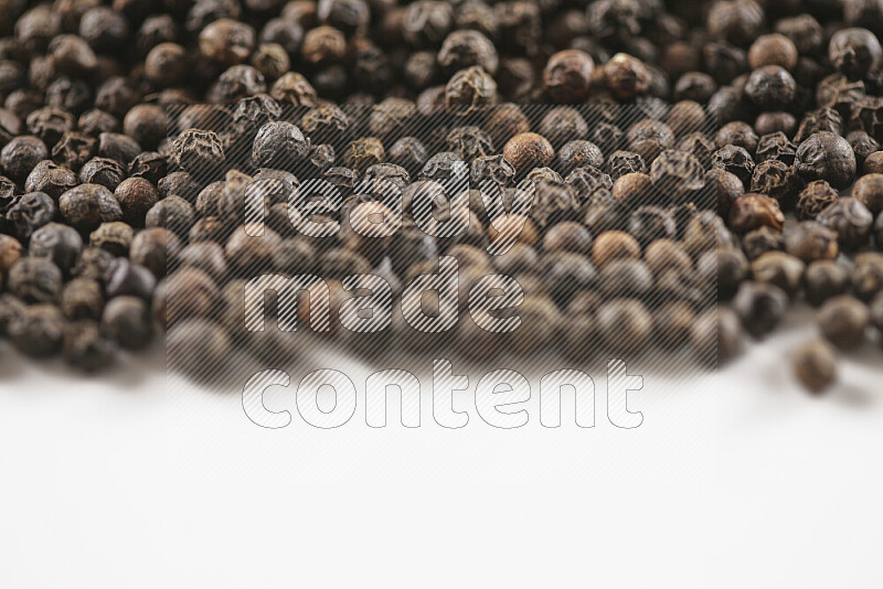 Black pepper beads on white background