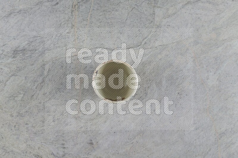 A multicolored pottery Cup on grey marble background