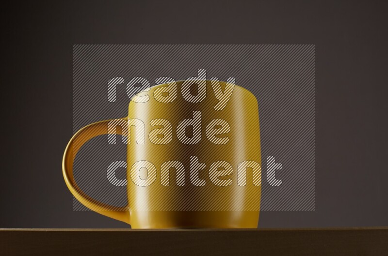 Low angle shot of a yellow cup on grey background