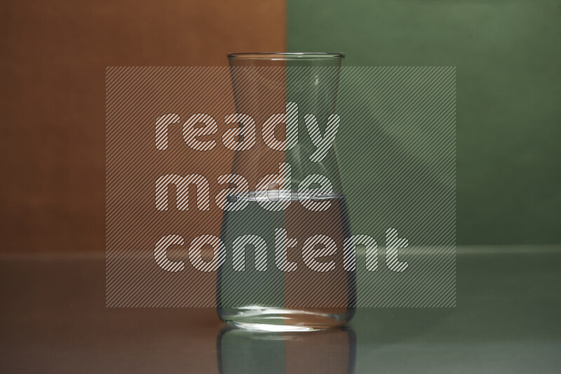 The image features a clear glassware filled with water, set against brown and dark green background