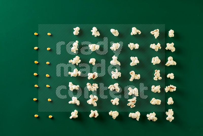 Popcorn flakes and seeds on a green background in a top view shot