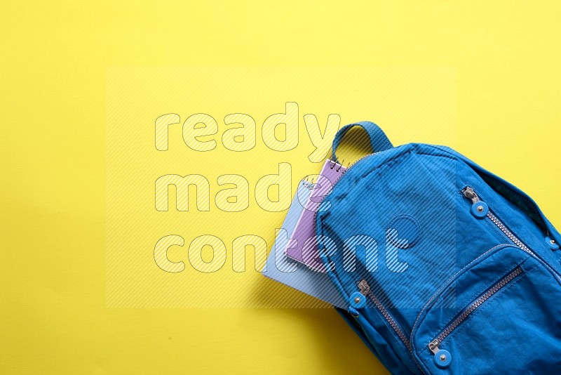 A school bag on yellow background (back to school)
